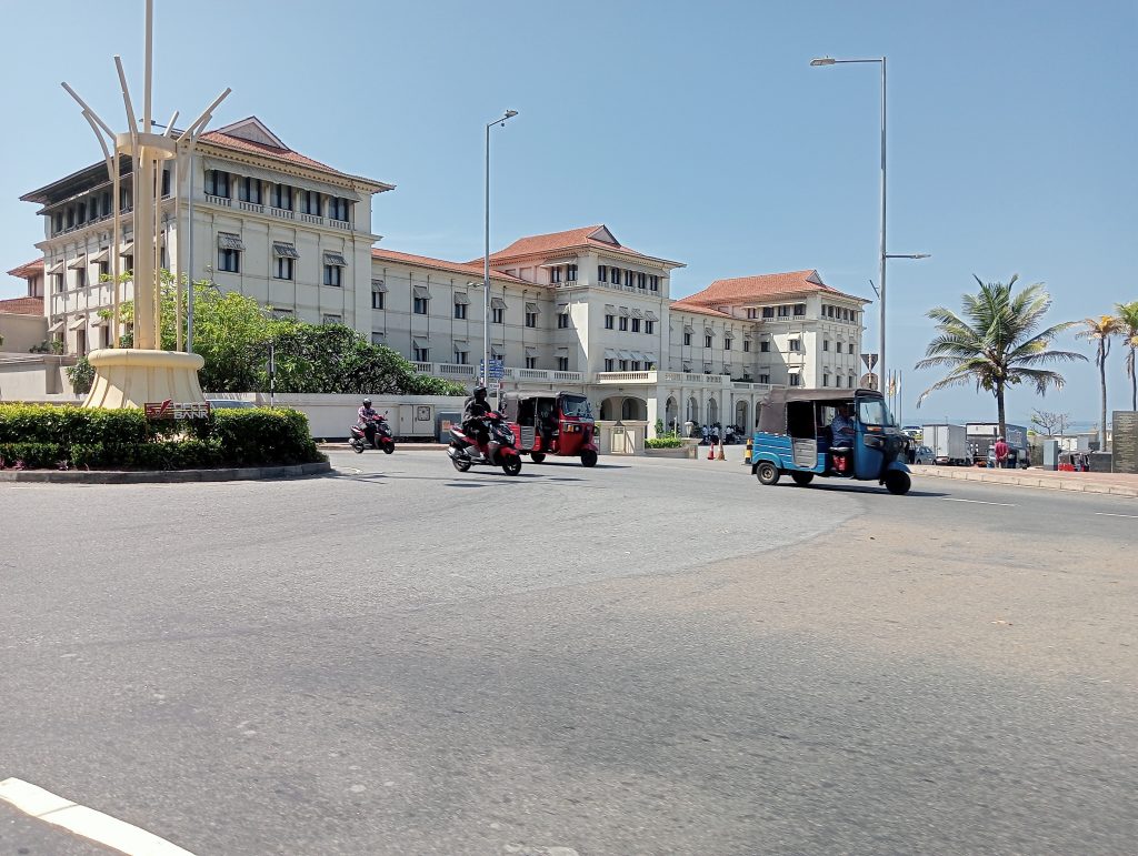 The imposing neo classical style old Sri Lankan Parliament on Galle Face Road with its white stone facade, tall columns and formal gardens