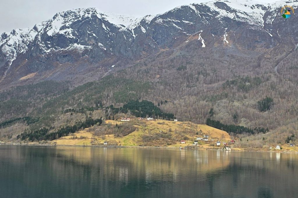 The view from our cabin arriving at Skoldjen. Mountains, snow, farmhouse reflected in the fjord
