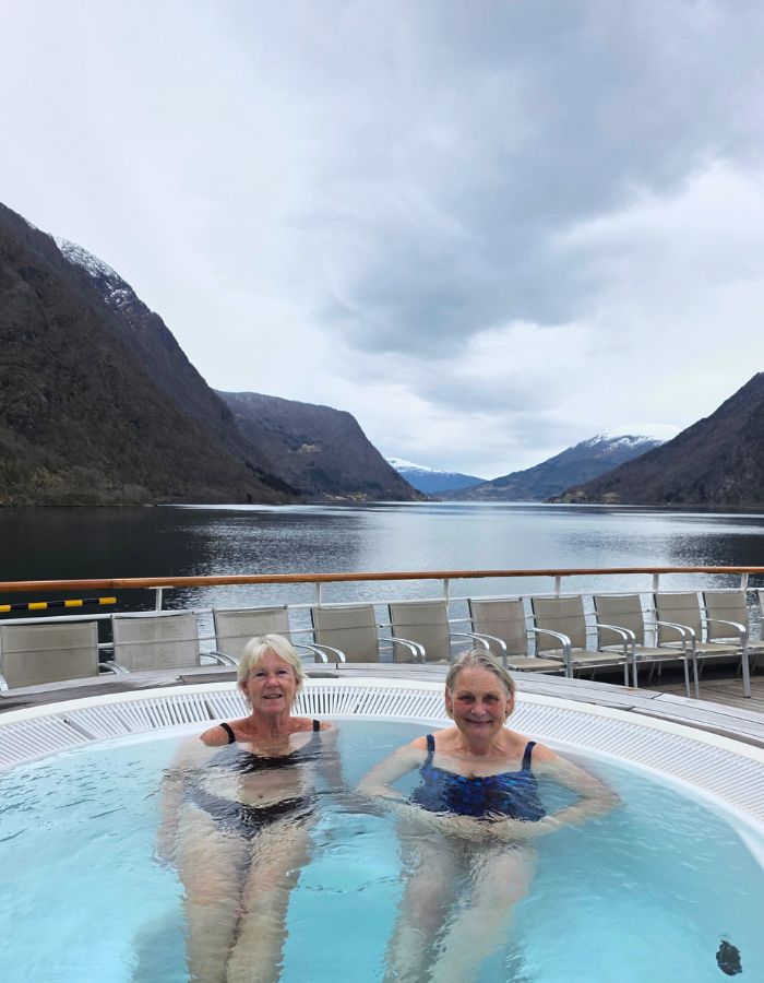 Sara and I in the hot tub with a superb view of snow capped mountains and the fjord